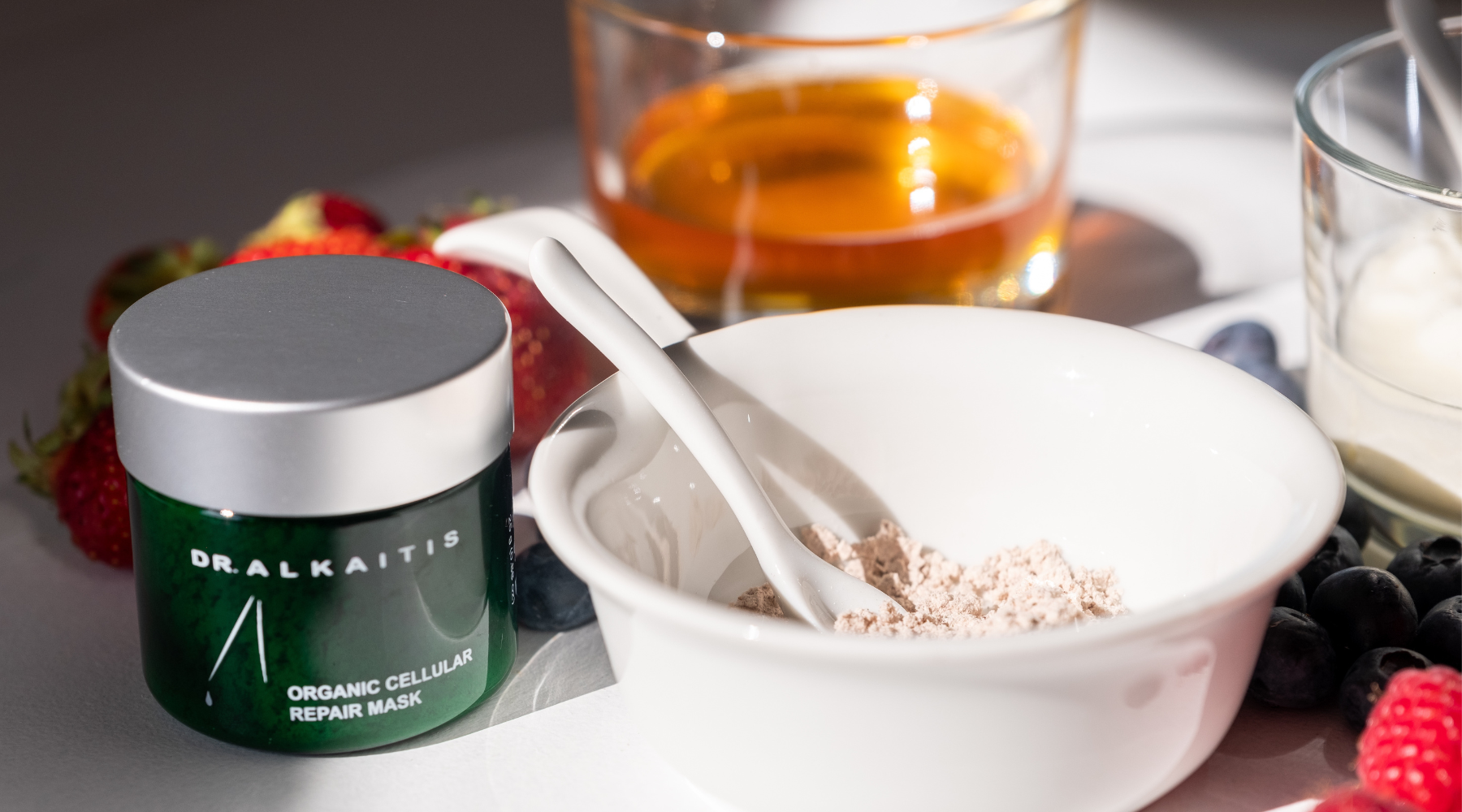 Jar of Dr Alkaitis Cellular Repair Mask with jar of honey, yogurt and dry mask powder in a bowl