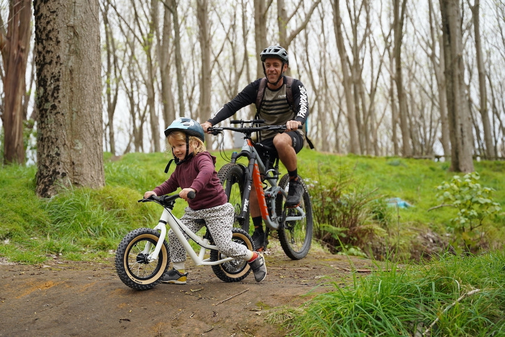 Balance bike kid riding on the trails