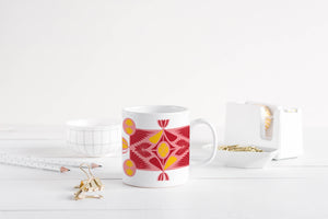 11 oz ceramic mug in pink, red and yellow art deco prints.