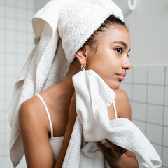 woman-wiping-face-with-face-towel