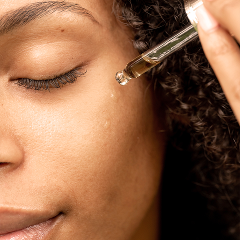 girl applying face oil