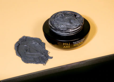 a swatch and pot of Pili Ani's Deep Detox Volcanic Exfoliating Mask