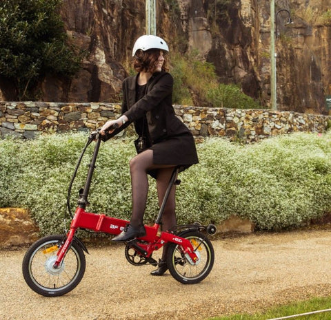 lady on a folding e bike looking backwards