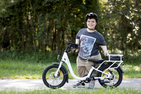 Short Stature rider next to white lightning electric bike