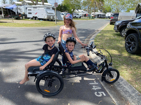 3 kids on electric trike at caravan park