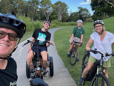 Family smiling while out for a bike ride