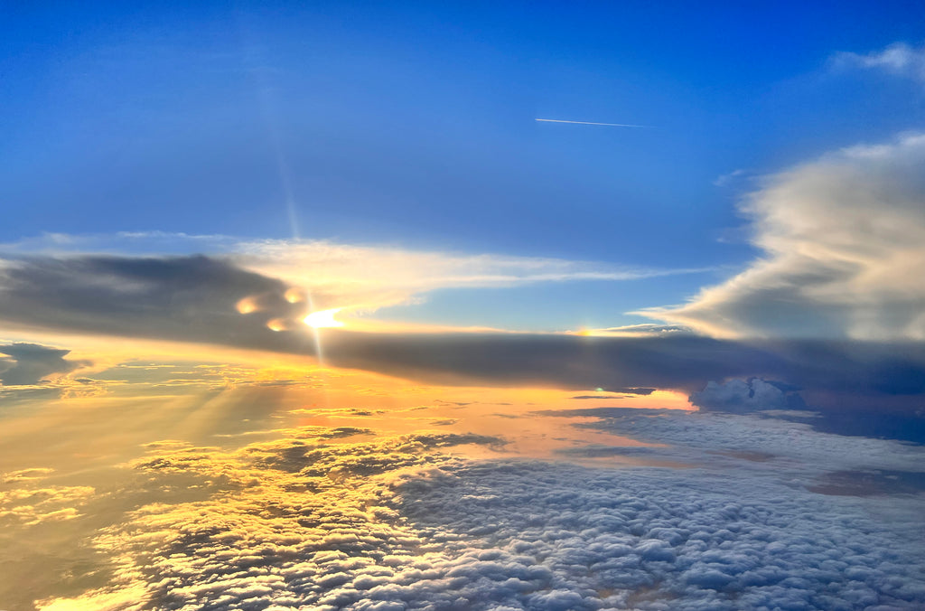 Blue sky captured while flying a plain above the clouds.  The clouds appear to be sand and snow. The image represents the essence of empowerment.  By SpaJuiceBar