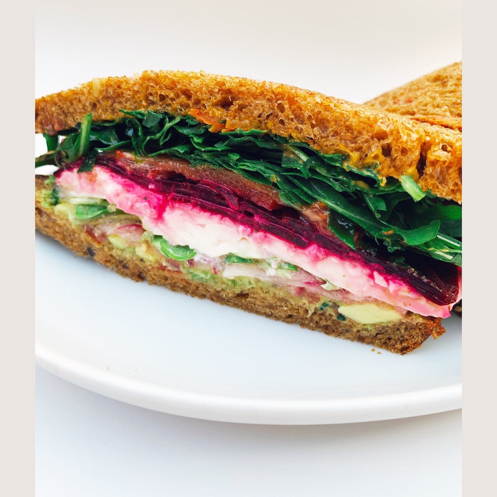 Image of A sandwich made with beets and tomatoes