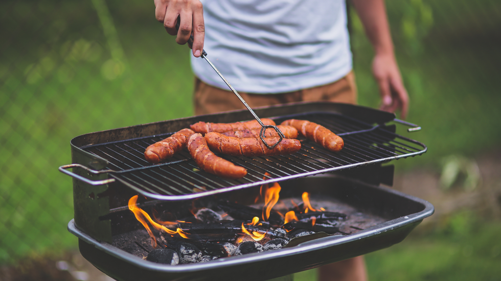 4th of july party must-haves: man grilling on a grill