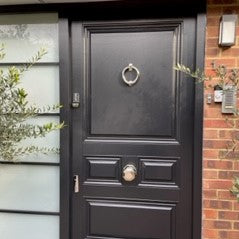 Black wooden front door with Finfort dual door lock set in Polished Chrome finish