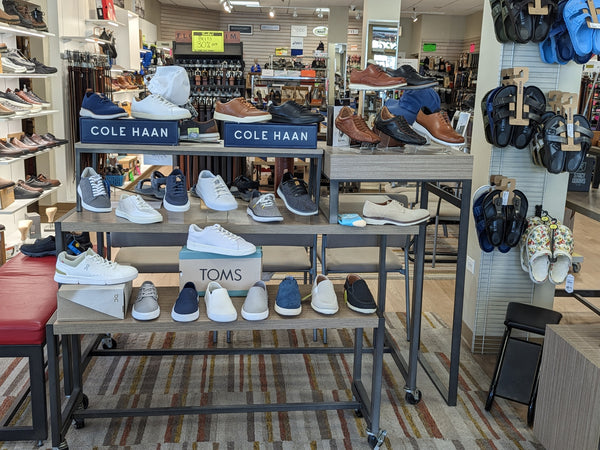 display rack with men's shoes on it
