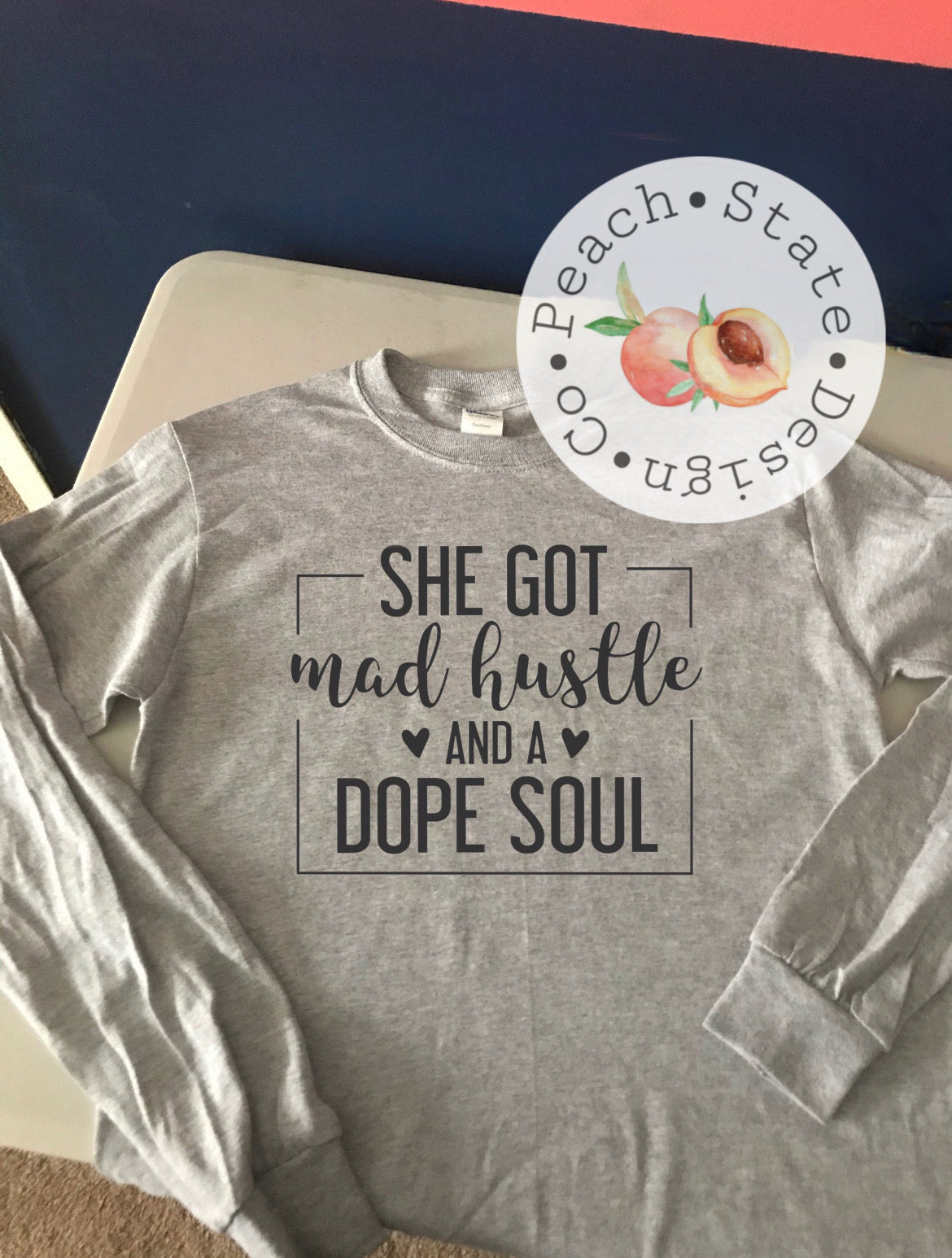 She got mad hustle & a dope soul tee