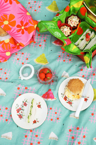 Scones-Strawberries-And-Cucumber-Sandwiches-On-A-Picnic-Blanket