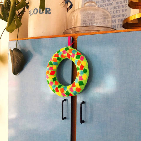 Colourful-Christmas-Wreath-Hanging-On-Cupboard-Door