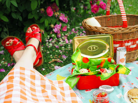 Lying-On-A-Picnic-Blanket-With-Sandwiches-And-Cakes