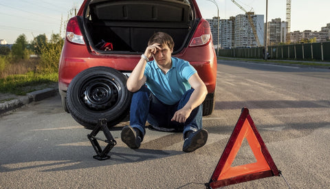 man-with-flat-tire-stops-on-the-side