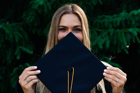 woman holding a mortarboard 