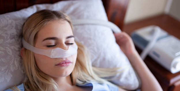Woman sleeping while using CPAP Mask