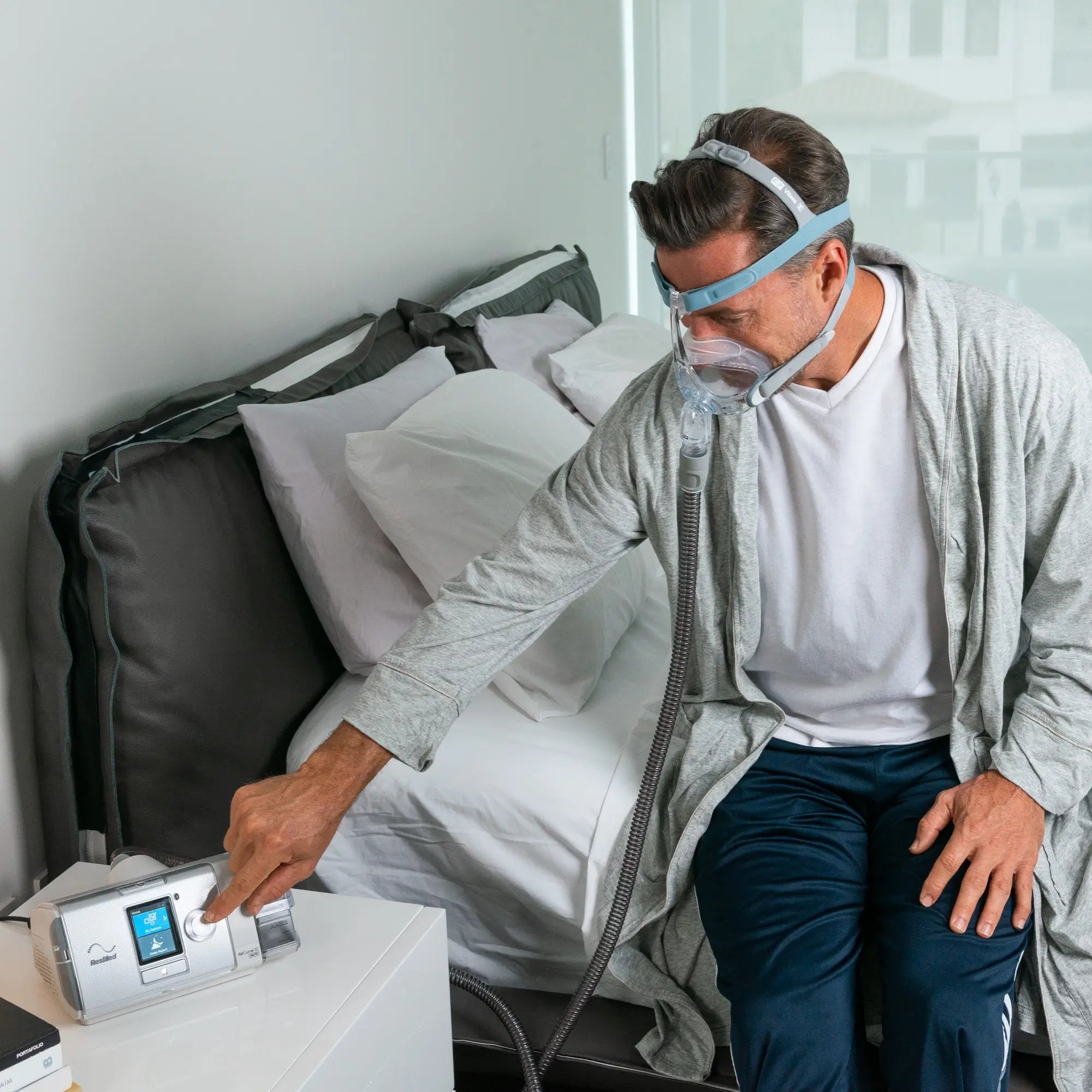man using the ResMed AirCurve 10 ASV BiPAP with HumidAir Heated Humidifier with a cpap mask