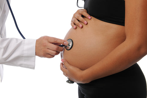 pregnant woman being examined by doctor