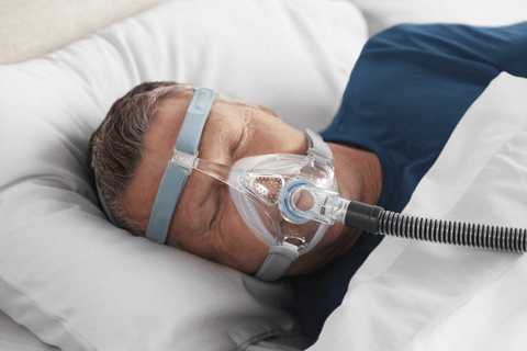 Man with sleep apnea using a CPAP mask while sleeping