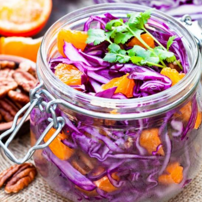 Orange slaw with purple cabbage and Fortune Favors The Classic candied pecans, served in mason jar