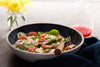 Bowl with spinach salad and spicy candied pecans