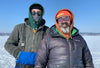 Eric Rupert and his son Colson dressed warmly on a frozen lake for ice fishing