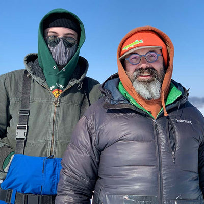 Eric Rupert and his son Colson dressed warmly on a frozen lake for ice fishing