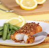 Spicy pecan-crusted fish fry on plate with peas and lemon
