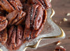 Up close picture of Fortune Favors candied pecans in a holiday gift bowl