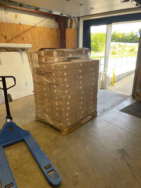 A large pallet wrapped and waiting for pickup at dock