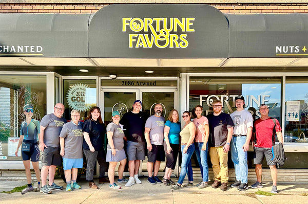 Fortune Favors staff in front of Fortune Favors shop