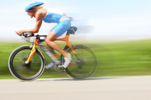 Woman racing on a bicycle - optimizing athletic performance.