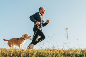 Man jogging with his dog - exercise helps prevent type 2 diabetes.