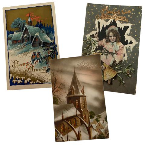 Vintage Christmas postcards of snowy scenes and an old photograph