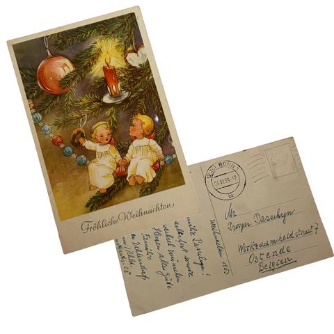 Vintage Christmas postcard of children sitting under the Christmas tree