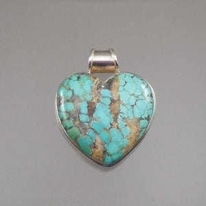 A vintage natural turquoise and sterling silver pendant. Heart shaped, handmade in a Southwestern US style design, signed KH. FREE Shipping to US locations