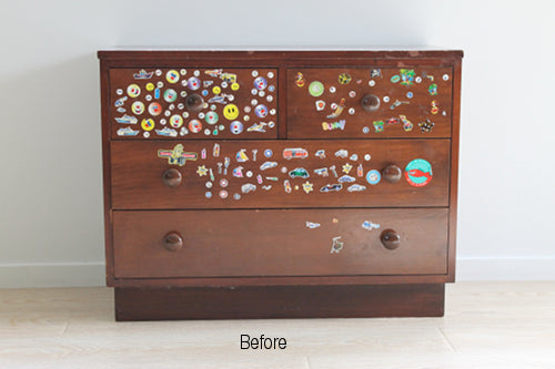 Dated lowboy with lots of stickers on the drawer front