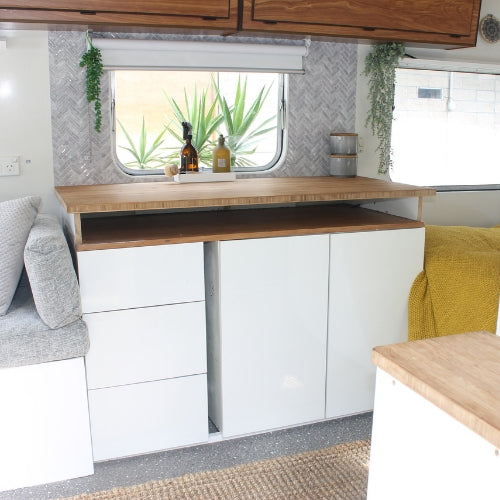 Grey peel and stick herringbone tiles as caravan splashback