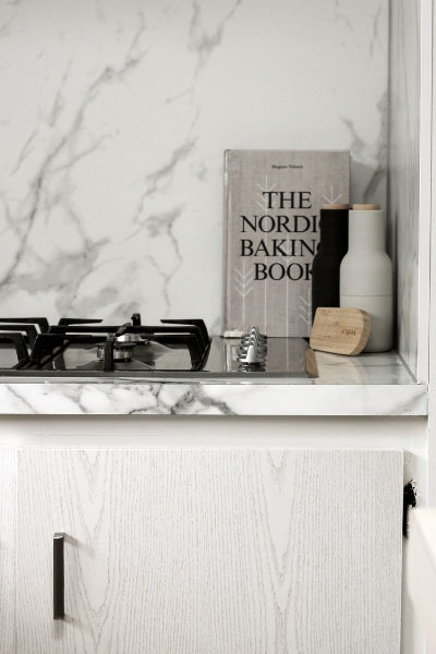 pearlwood white vinyl wrapped kitchen cupboard and grey marble bench top and splash back