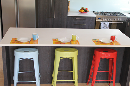 Kitchen breakfast bar with blue, green and red bar stools