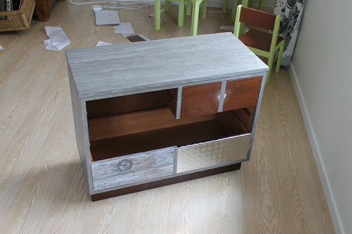 lowboy drawer unit partly covered in grey wood grain vinyl