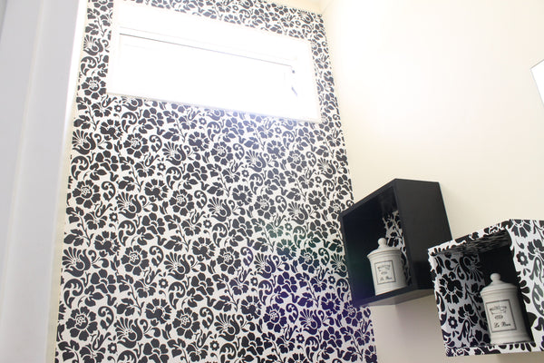 black and white flower vinyl wallpaper on bathroom wall and box shelves