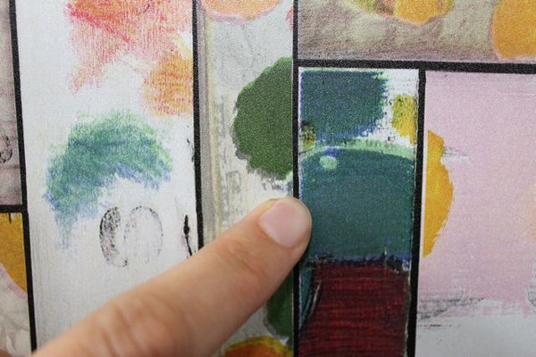 finger pointing on black line in colourful patchwork vinyl