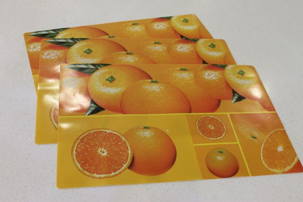 oranges patterned placemats laid flat on bench
