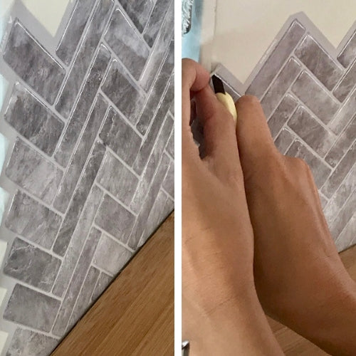 close up of self-adhesive wall tiles being trimmed with yellow craft knife after applied to wall