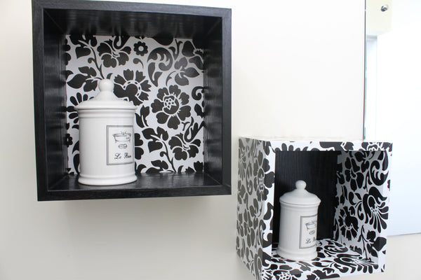 two boxed shelves in black and white flower patterned vinyl on white wall