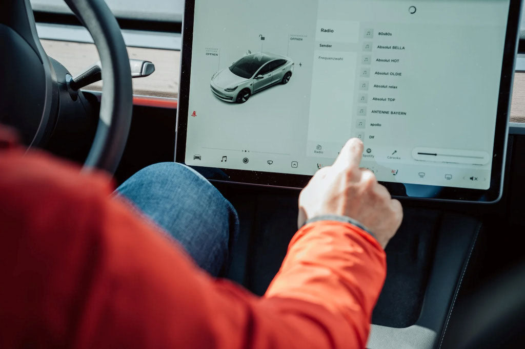 Person using the touchscreen inside a Tesla