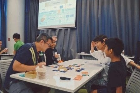 Playing coding card game to rise interest in computer science for kids
